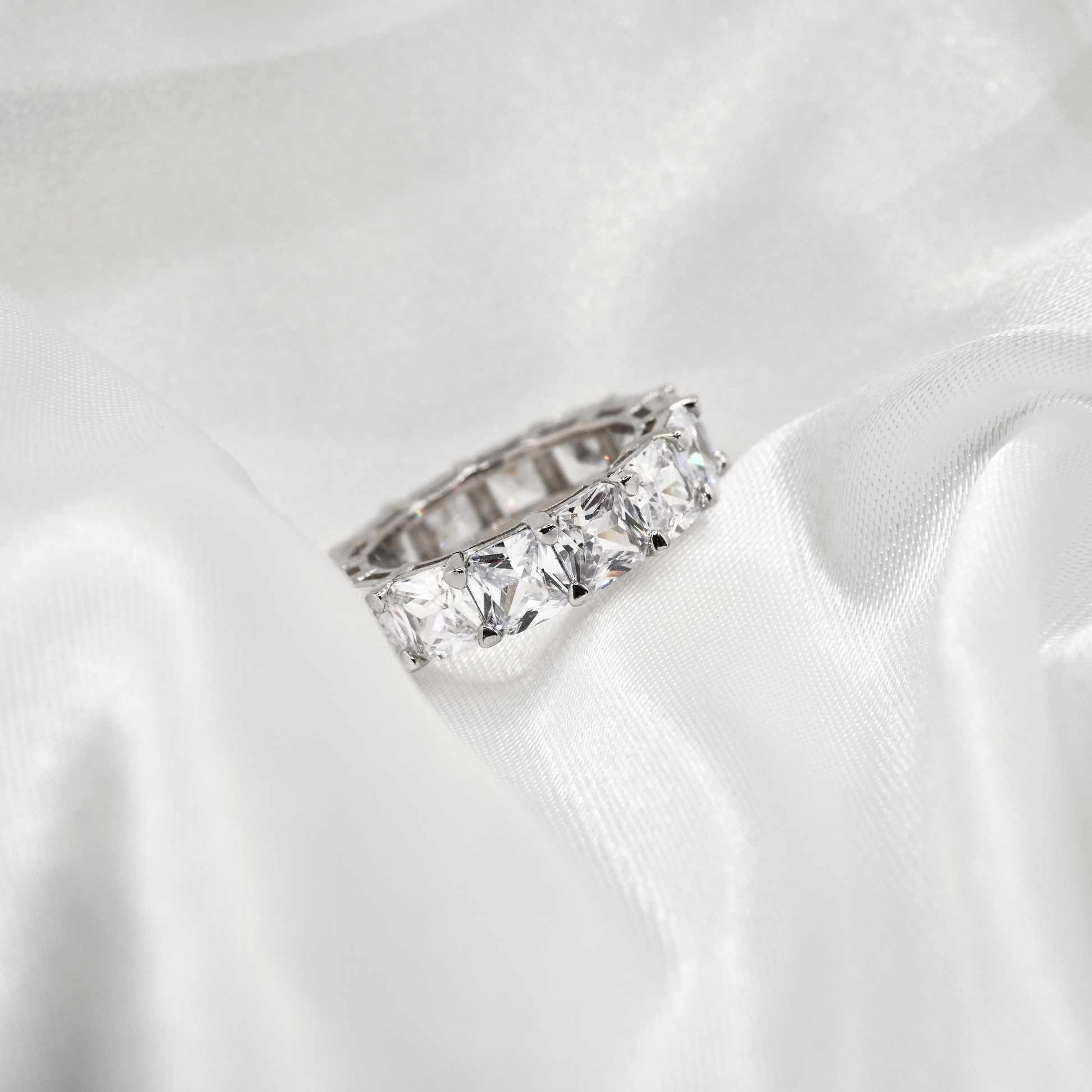 Diamond ring on a white satin background